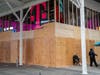 A person walks by a boarded up a T-Mobile store in Times Square on November 1, 2020 in New York City.