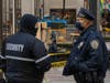 A police officer and a security guard chat as workers board up windows at Rockefeller Center in anticipation of unrest related to the presidential election on November 2, 2020 in New York City. 