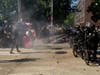 Police use pepper spray as non-lethal munitions litter the street during protests in Seattle on July 25, 2020.