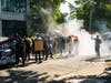Demonstrators use dumpsters and shields for protection from police during protests in Seattle on July 25, 2020.