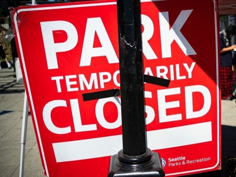 Protesters repurpose a sign that was posted while police conducted a sweep of Cal Anderson Park in the area formerly known as CHOP on August 14, 2020 in Seattle.