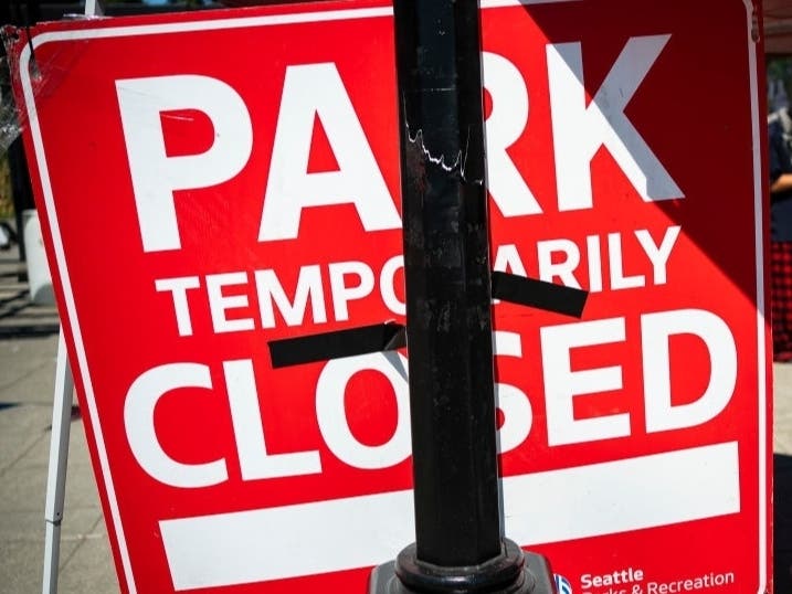 Protesters repurpose a sign that was posted while police conducted a sweep of Cal Anderson Park in the area formerly known as CHOP on August 14, 2020 in Seattle.