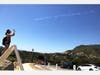 A woman takes photos as a team of volunteer pilots from Skytypers produce skywriting messages including ‘Stay Strong LA’ above Hollywood amid the coronavirus pandemic on April 25, 2020 in Los Angeles, California. 