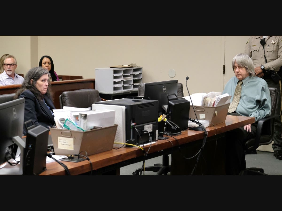 Louise Ann Turpin (left front) and her husband, David Allen Turpin (far right), appear in court in 2018. Both are now serving 25 years to life in prison for imprisoning and torturing 12 of their 13 children in what was described as a house of horrors.