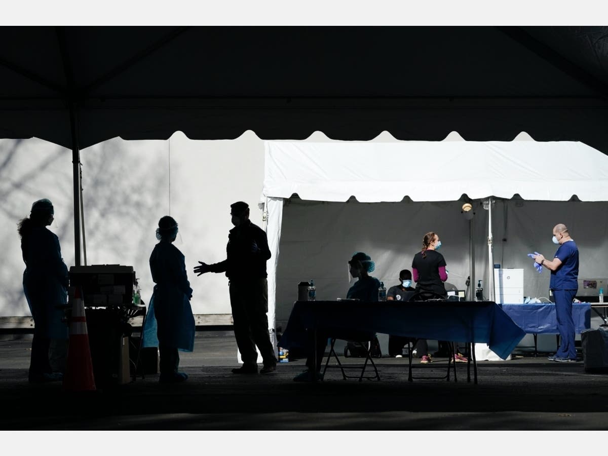 Medical professionals and volunteers work at a drive-thru coronavirus testing site run by George Washington University Hospital on Monday in Washington, DC.