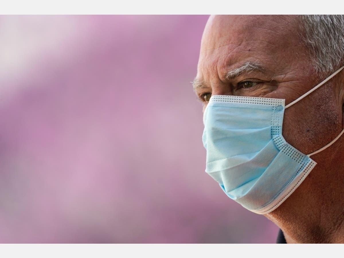A volunteer wears a face mask while directing traffic at a drive-thru coronavirus testing site run by George Washington University Hospital on April 6.