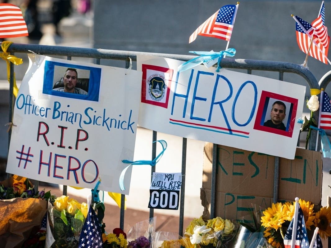  A memorial for Brian Sicknick, U.S. Capitol Police Officer who died from injuries following the U.S. Capitol building siege on Wednesday, is erected near the U.S. Capitol on Sunday in Washington, D.C.