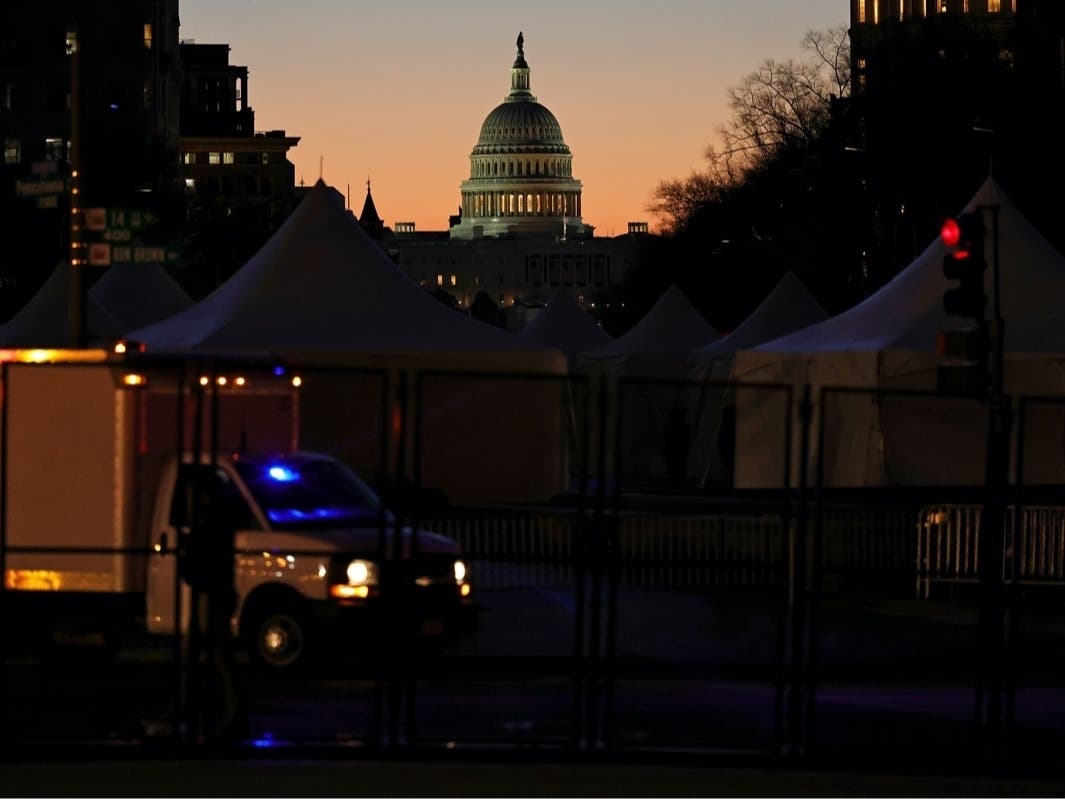  The U.S. Capitol is seen behind barricades and a checkpoint during sunrise on Saturday in Washington, D.C.