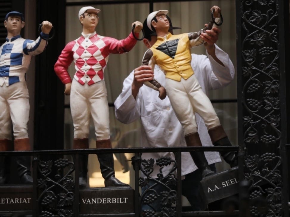 Workers take down the iconic jockey statues from the front of the 90-year-old Midtown restaurant the 21 Club on Dec. 14.