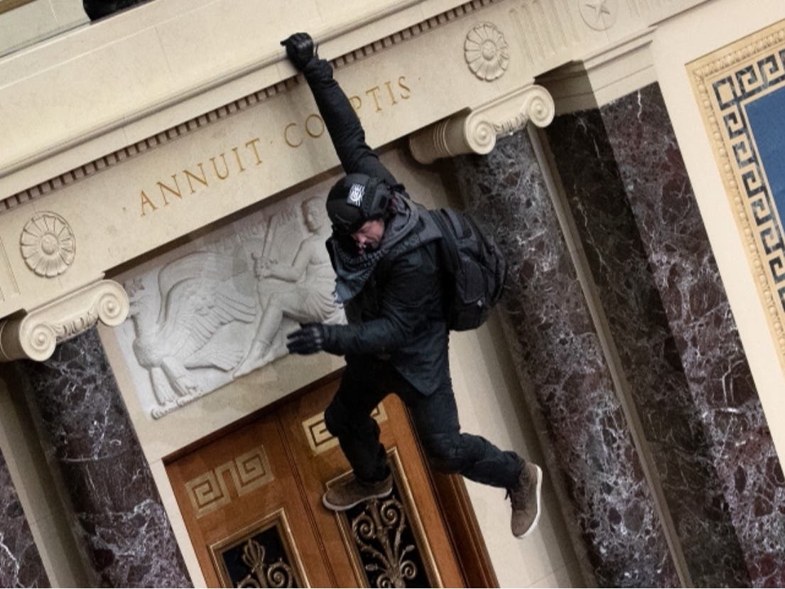 A Trump supporter jumps from the public gallery to the floor of the Senate chamber at the U.S. Capitol Building on Jan.6.