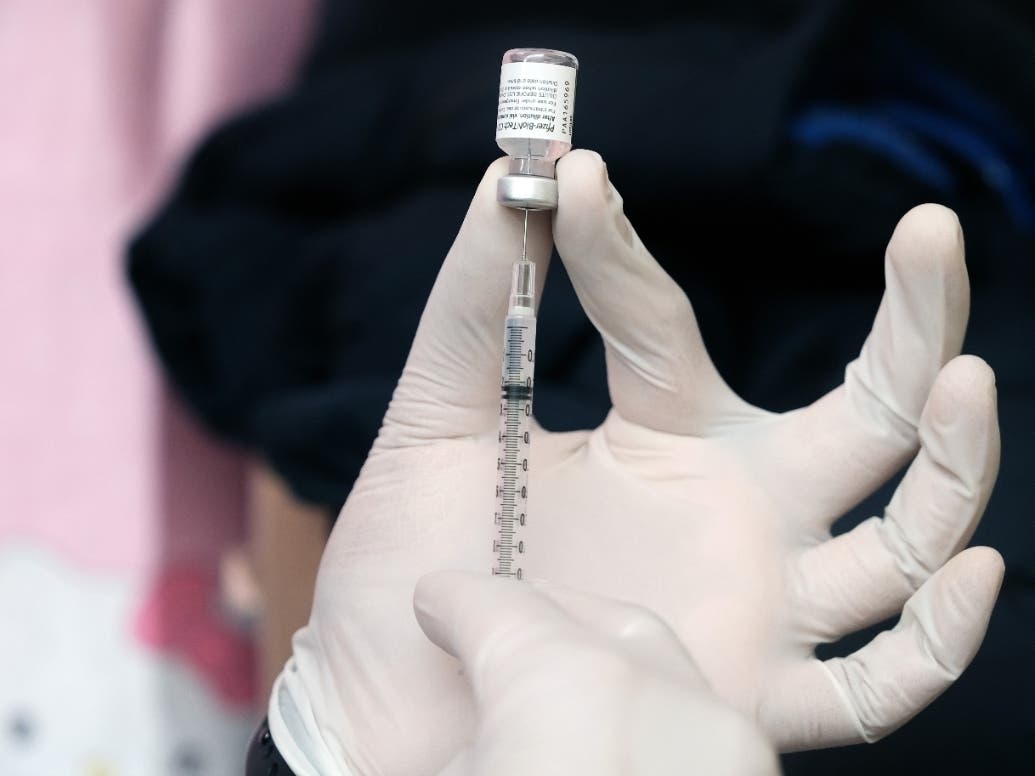 A pharmacist prepares the Pfizer vaccine at a pop-up vaccination clinic in Chinatown on March 26.