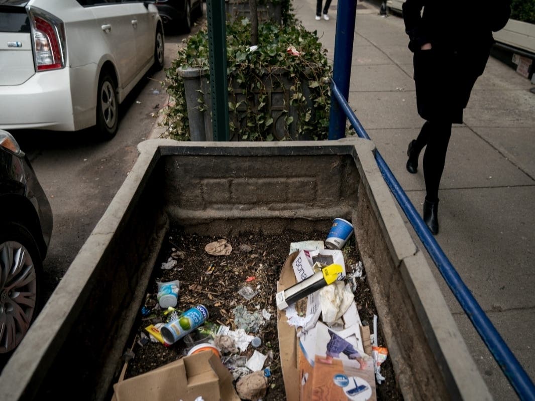 Trash sits in a planter on the sidewalk in Lower Manhattan, Feb. 22, 2018.