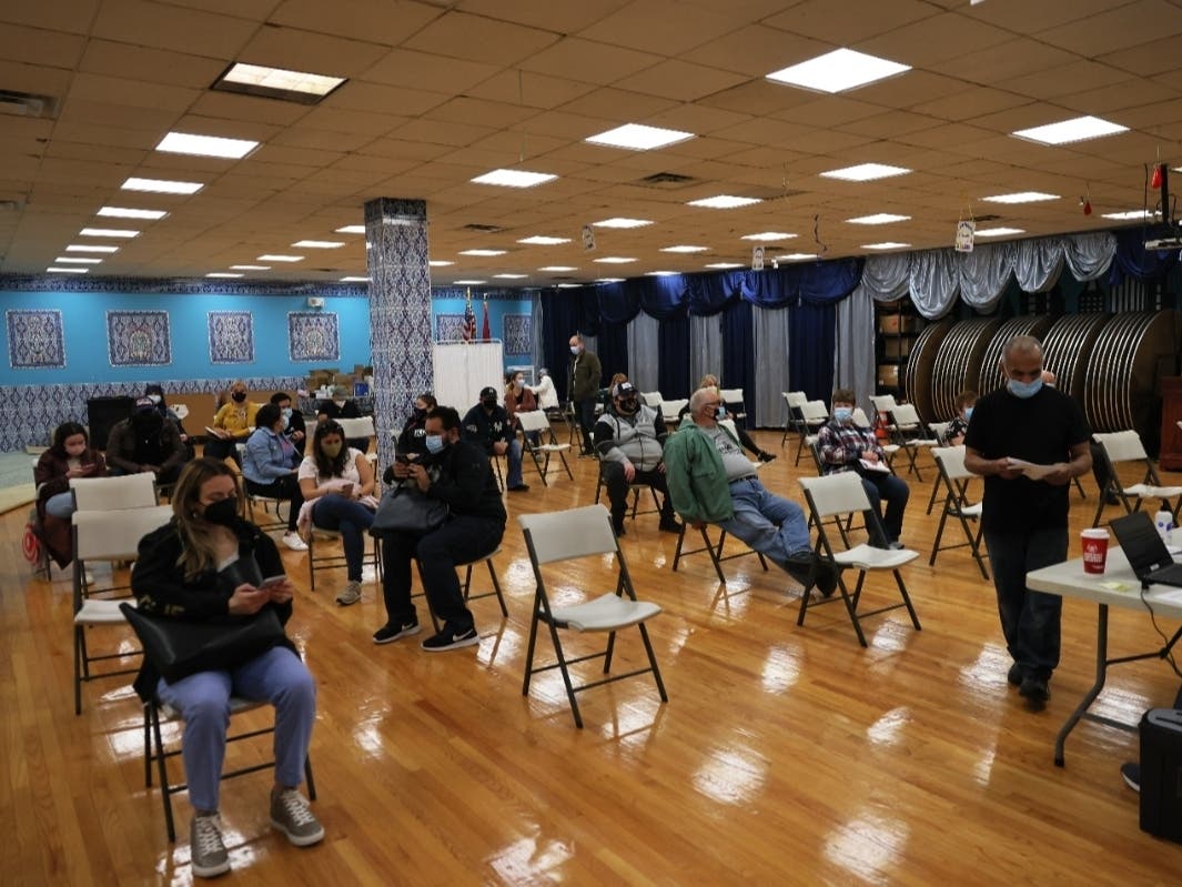 People sit in a waiting area to monitor for possible side effects at a Northwell Health pop-up coronavirus vaccination site in Staten Island on April 8 — the day the city set a record for most vaccinations.