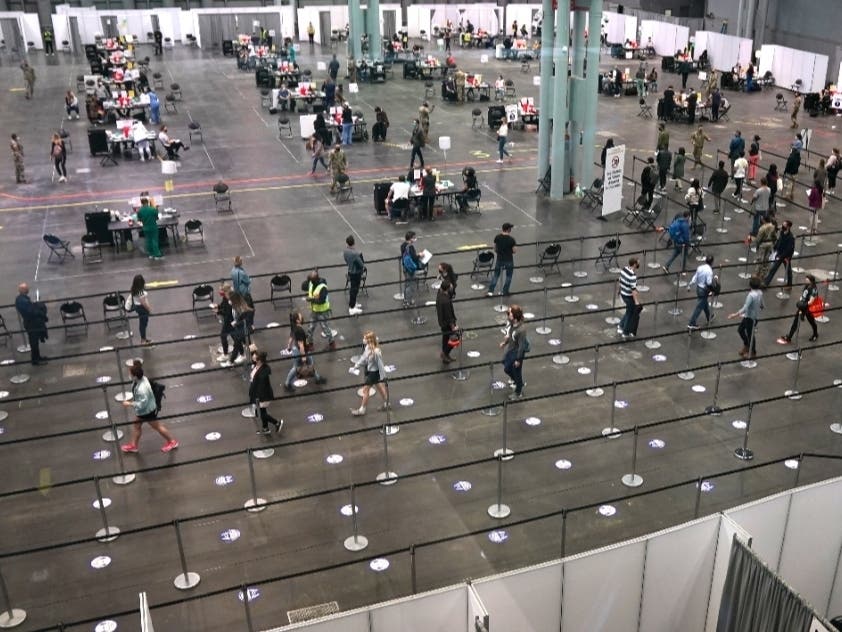 People wait in line at the Jacob K. Javits Convention Center transformed into a Covid-19 vaccination center on April 6.