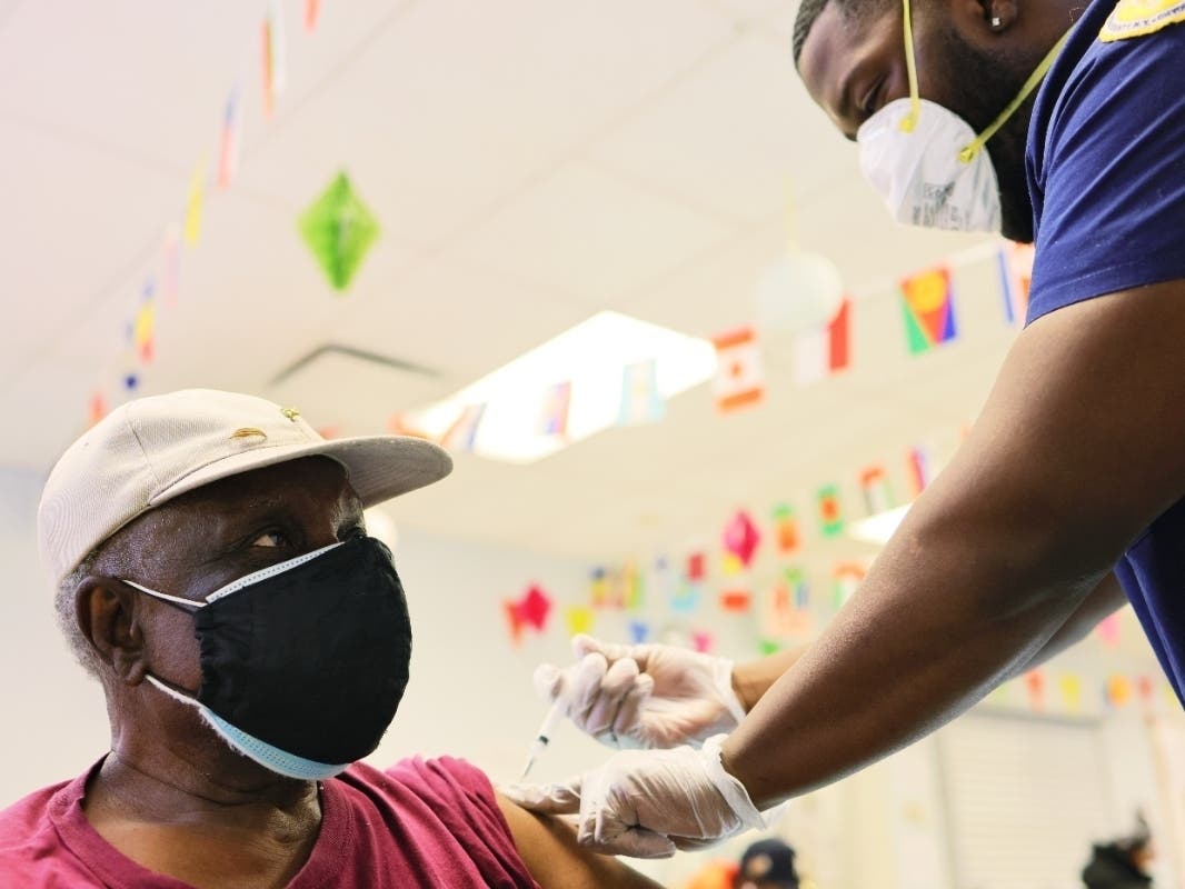 Robert Davis, 77, is given the Moderna coronavirus vaccine by Kurtis Smith at Red Hook Neighborhood Senior Center on Feb. 22.