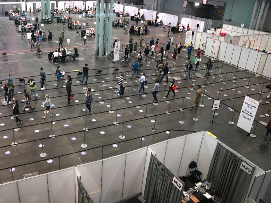 People wait in line at the Jacob K. Javits Convention Center transformed into a Covid-19 vaccination center on April 6.