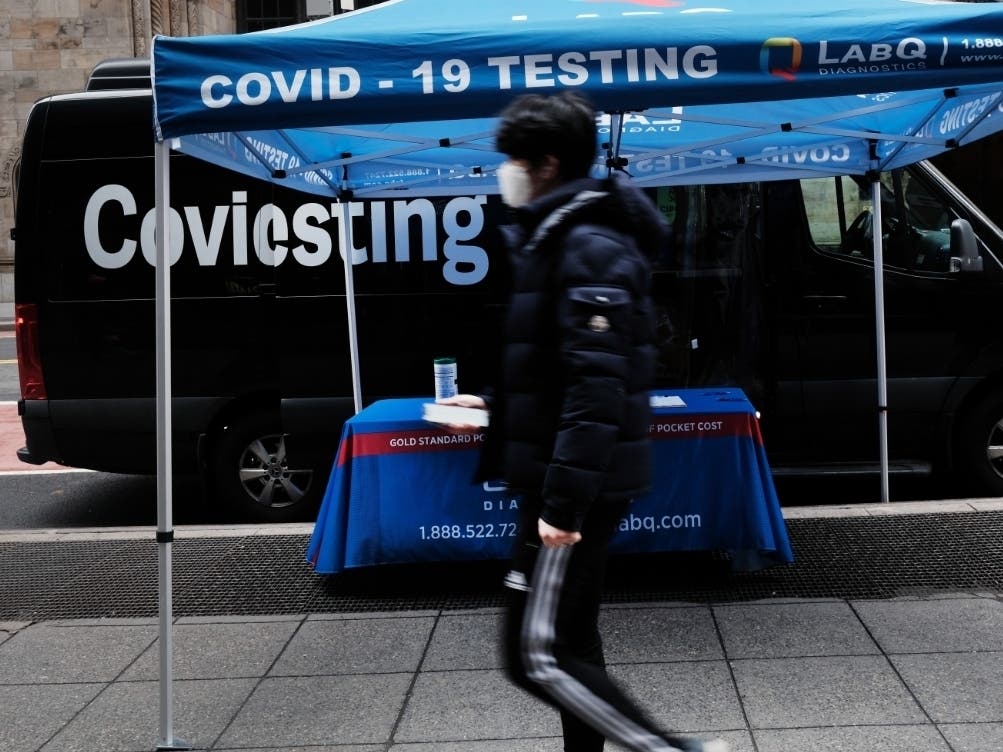 People walk by a COVID-19 testing site in Manhattan on March 1.