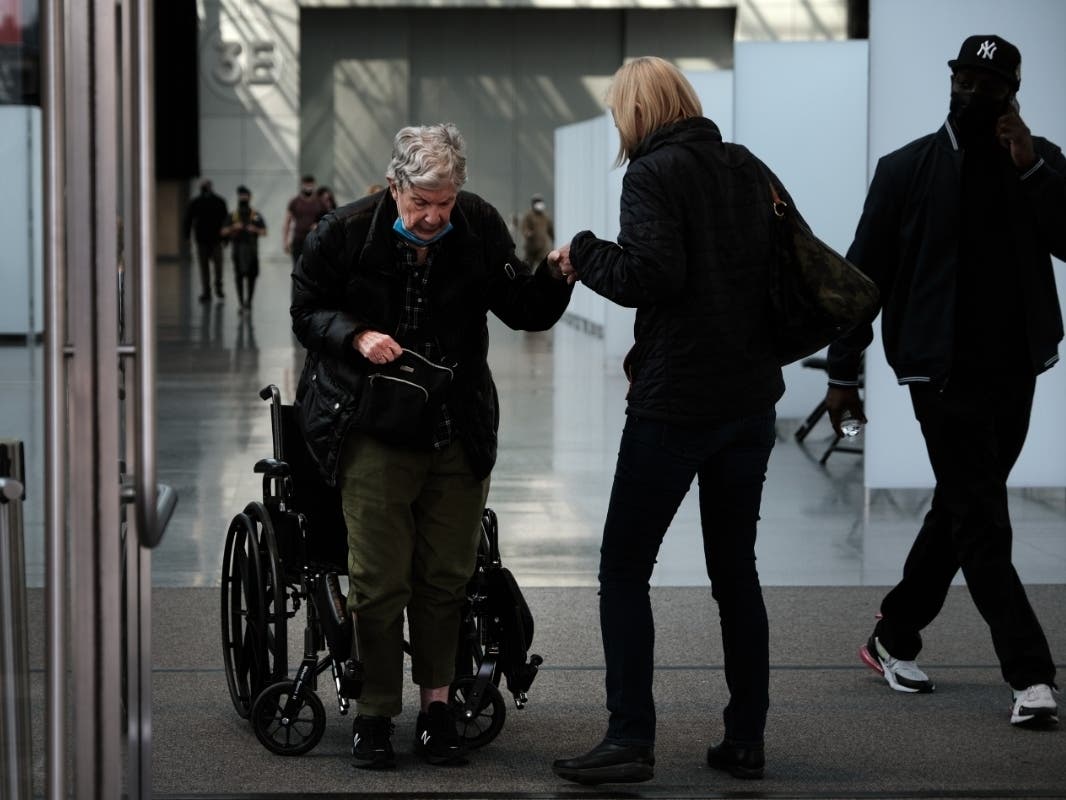 People enter and exit the Javits Center Covid-19 vaccination site on March 23.