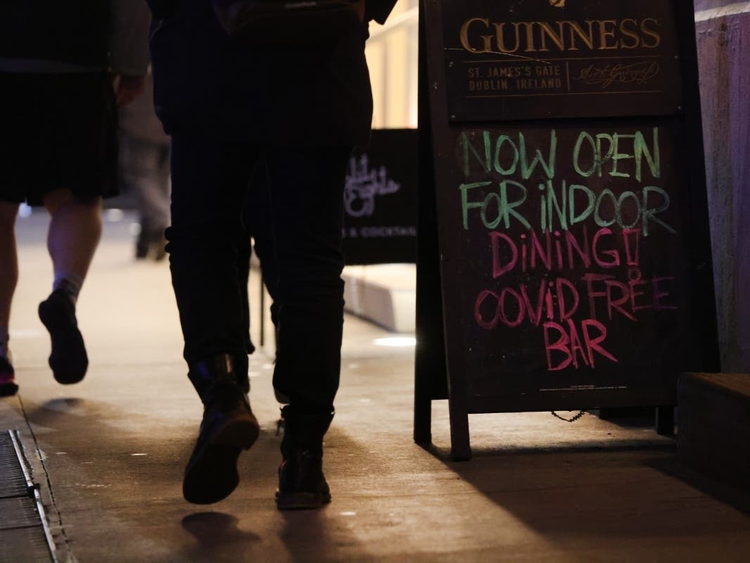 A sign outside of a bar looks to draw customers in Manhattan on Dec. 9.