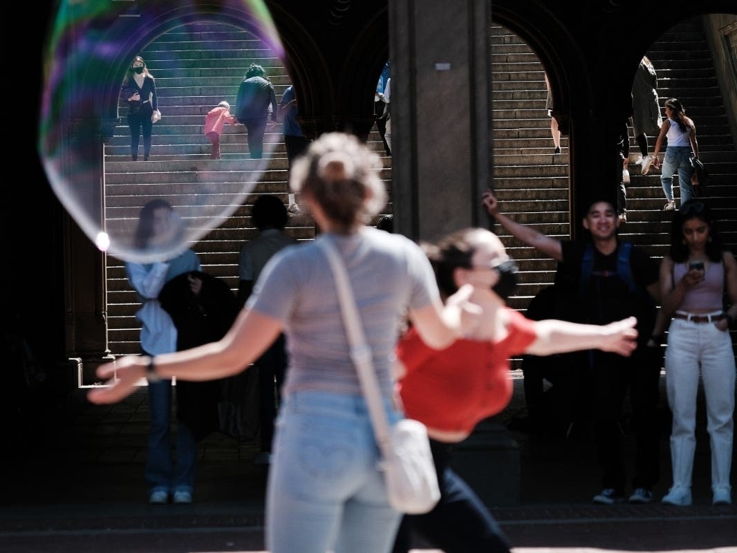 People walk through a pavilion in Central Park on May 06. As New York City begins to reopen following pandemic lockdowns, thousands are flocking to city parks, restaurants and cultural events.