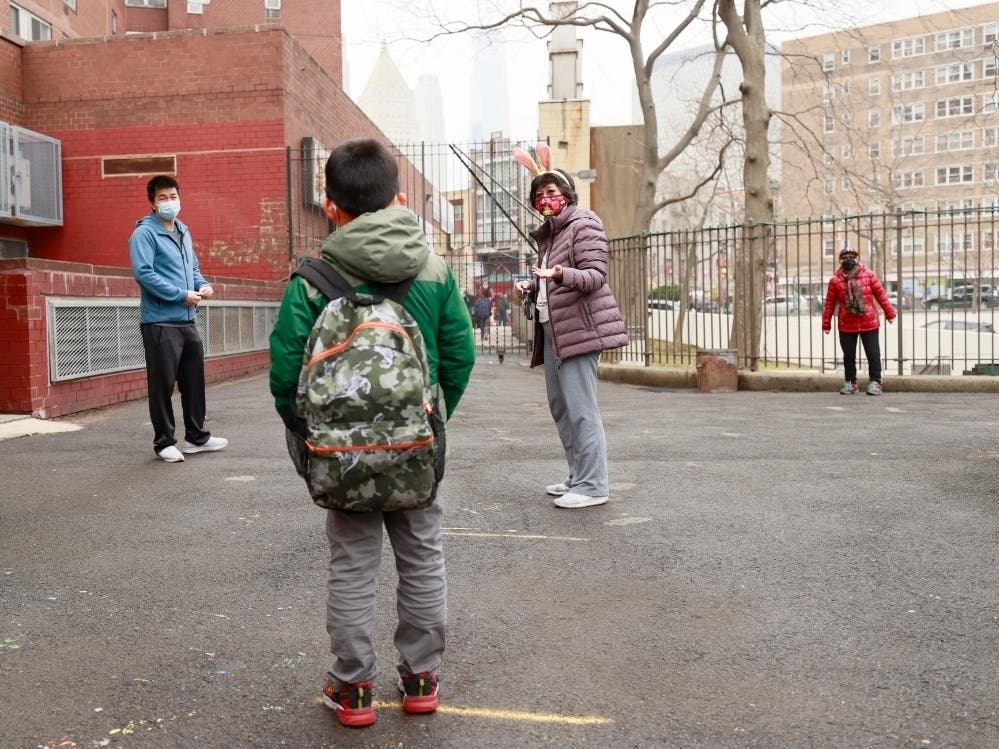 Principal Alice Hom, second on right, chaperones students to be picked up by their guardians at school's end at Yung Wing School P.S. 124 on March 25.