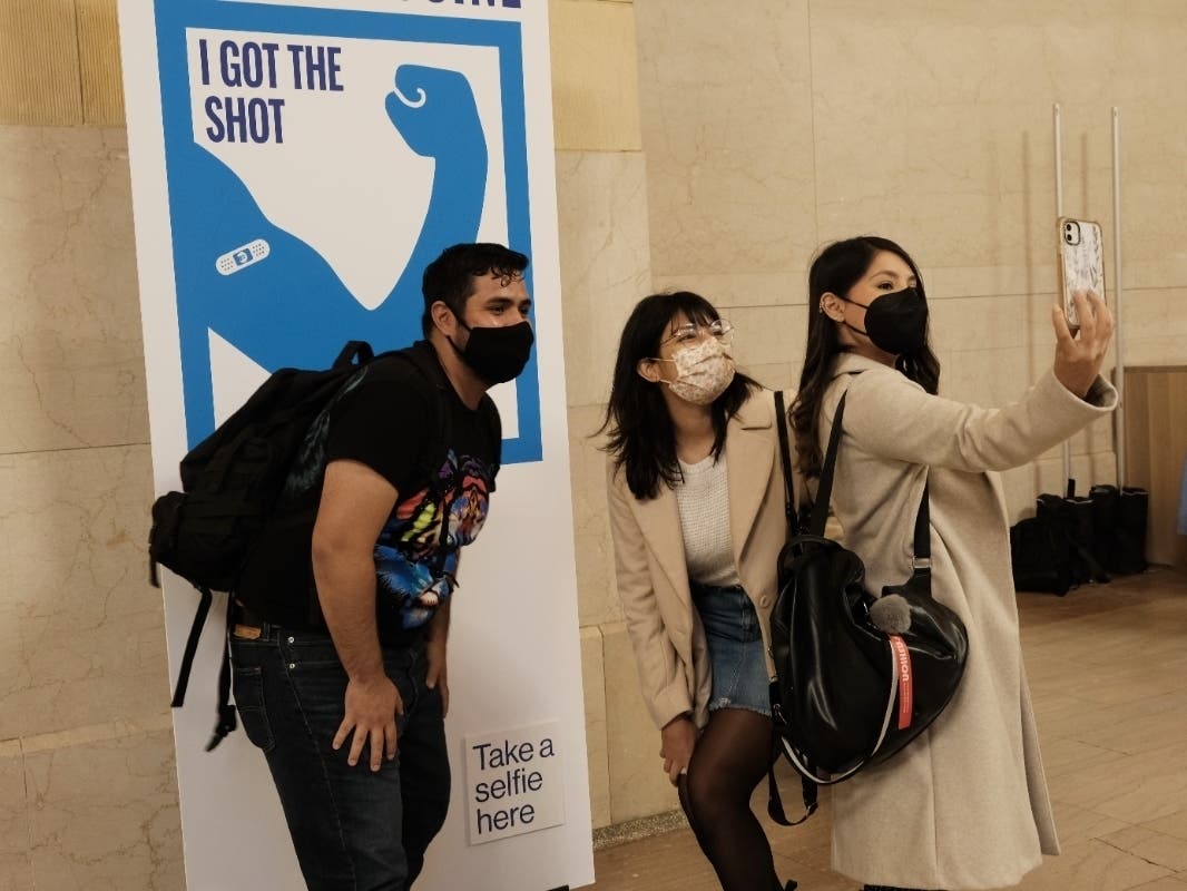 People pose for a picture after getting COVID-19 vaccinations at Grand Central Terminal on May 12.