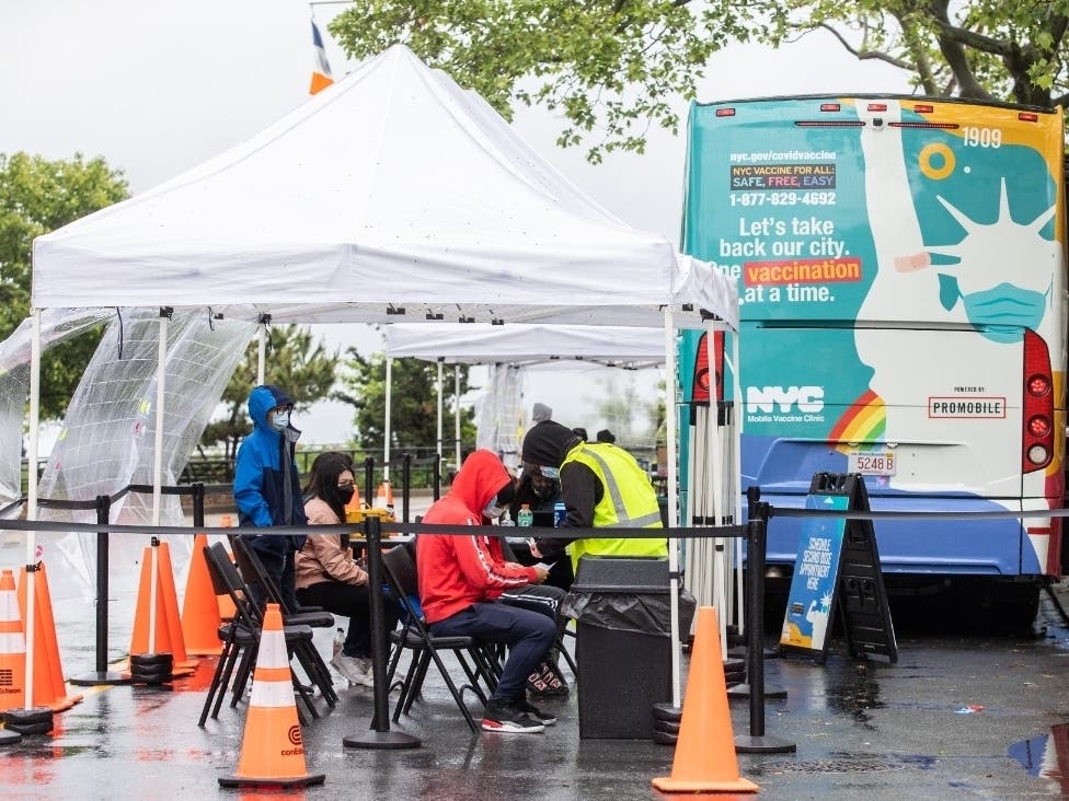 People wait for making a second appointment after vaccinated at NYC mobile vaccination clinic bus near Brighton beach on May 29.