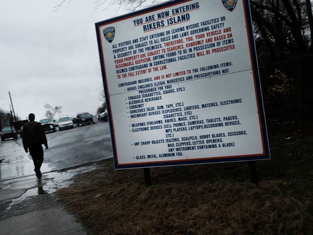 A man enters the road to Rikers Island on March 31, 2017.