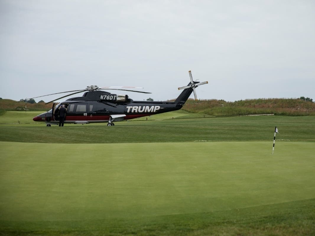 A 'TRUMP' branded helicopter sits near a putting green during a ribbon cutting event for a new clubhouse at Trump Golf Links at Ferry Point, June 11, 2018.