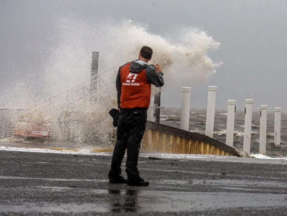 A man watches as Tropical Storm Elsa makes landfall on July 7 in Cedar Key, Florida.