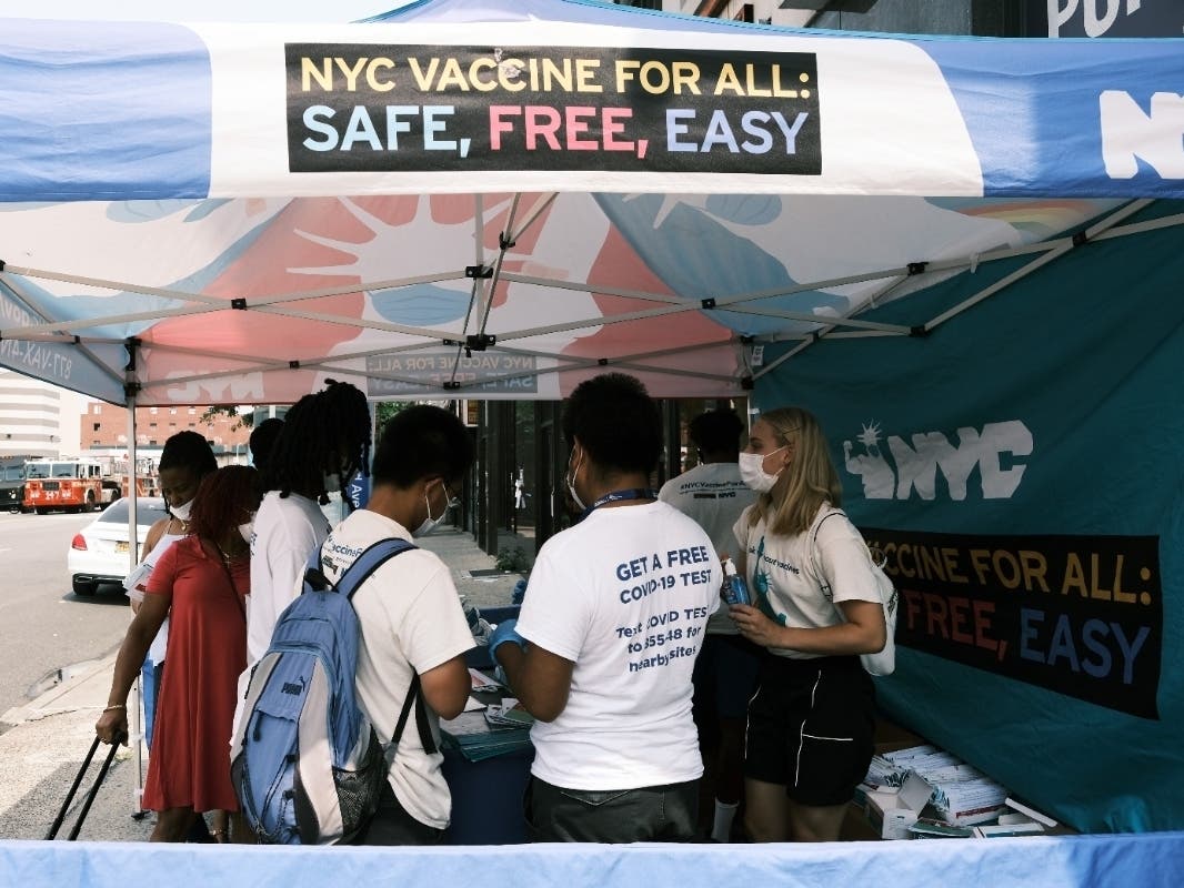 A city-operated mobile pharmacy advertises the COVID-19 vaccine in a neighborhood near Brighton Beach on Monday.