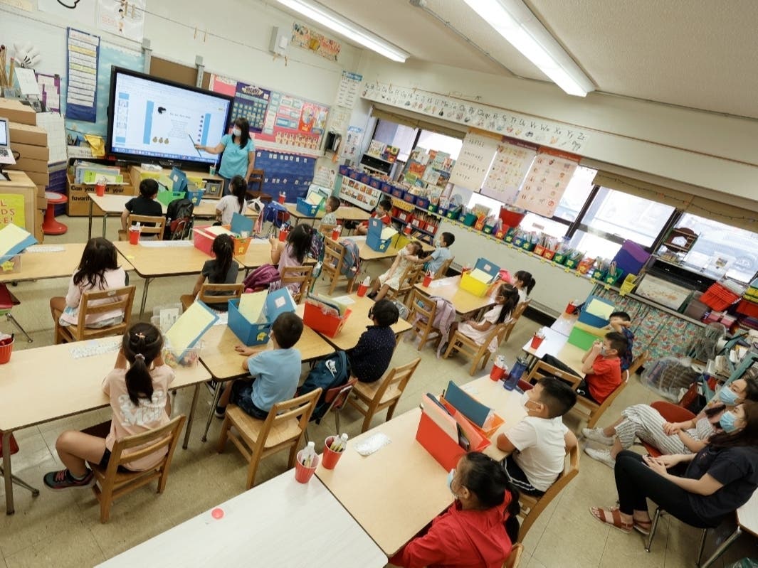 Melissa Moy, a teacher at Yung Wing School P.S. 124, goes over a lesson with in-person summer program students on a monitor on July 22.