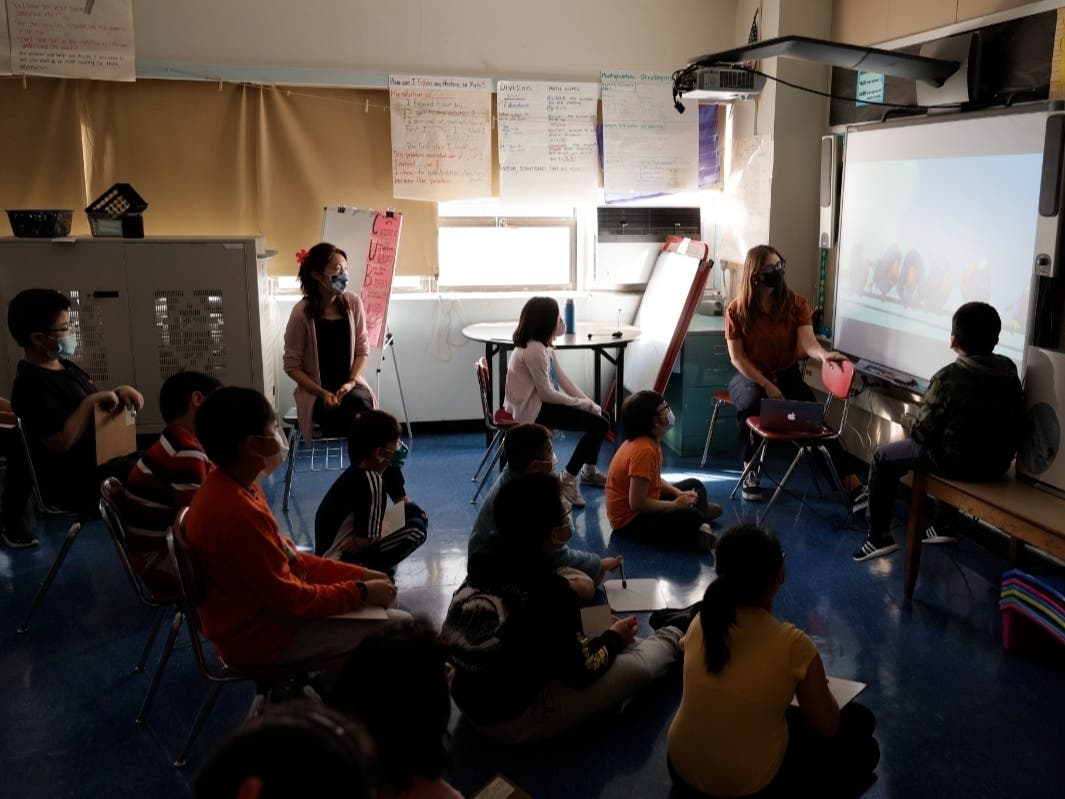 Co-teachers give a lesson to their masked students in their classroom at Yung Wing School P.S. 124 on Sept. 27.