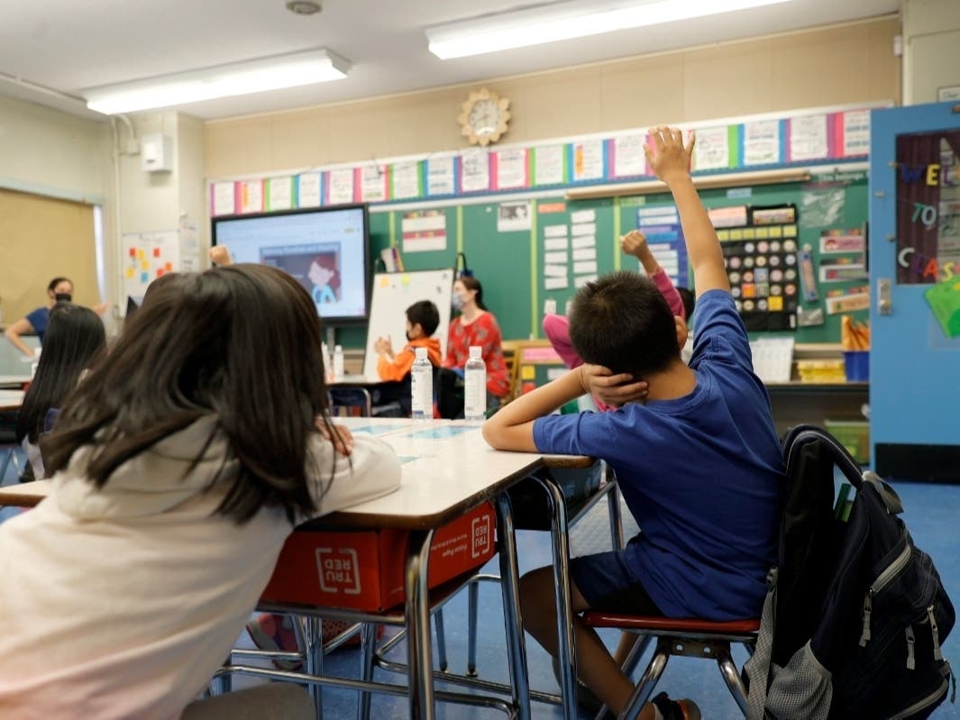 Co-teachers at Yung Wing School P.S. 124 Marisa Wiezel (who is related to the photographer) and Caitlin Kenny give a lesson to their masked students in their classroom on Sept. 27.