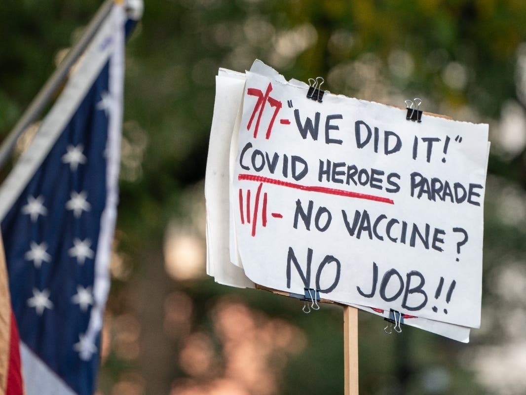 People march across the Brooklyn Bridge to protest the COVID-19 vaccine mandate for municipal workers on Monday.