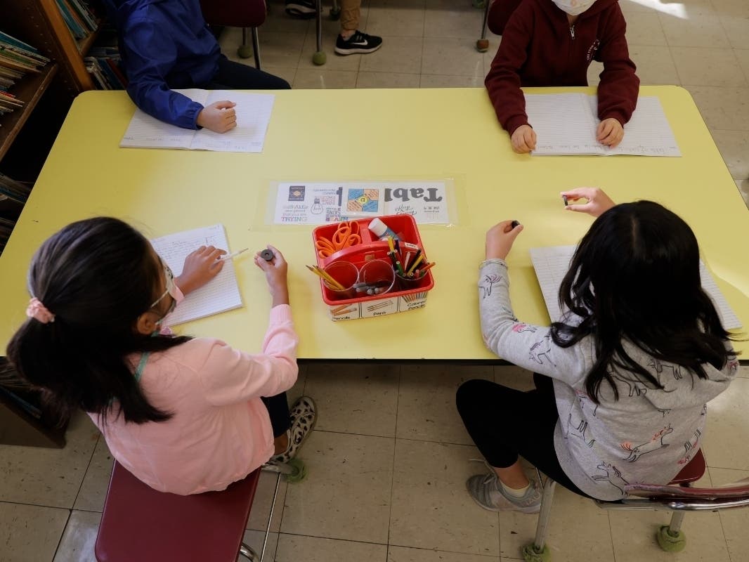 Masked students participate in a lesson in their classroom at Yung Wing School P.S. 124 on Sept. 27.