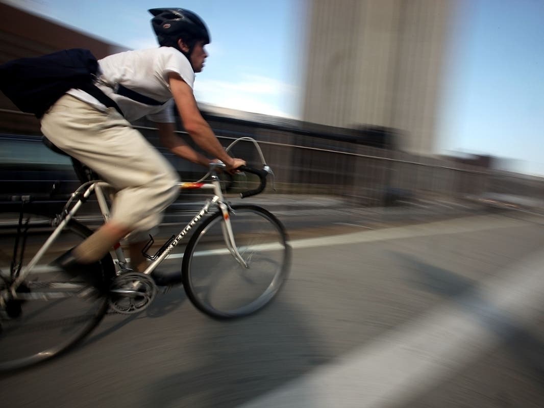 A cyclist crosses the Brooklyn Bridge during the evening commute Aug. 25, 2009.