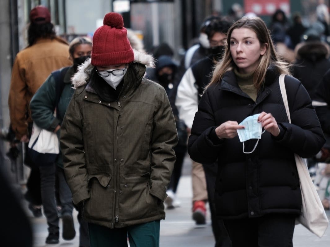 People wear face masks in Manhattan on Nov. 29.
