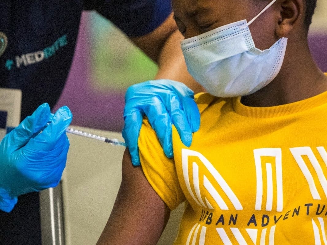 Tse Cowan, 8, winces as he is administered the coronavirus vaccine at a vaccination pop-up site at P.S. 19 on Nov. 8.