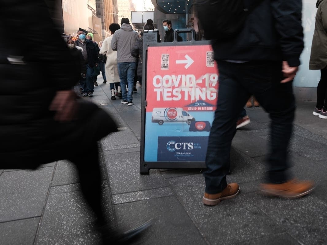 Groups of people line-up to get tested for COVID-19 in Times Square on Dec. 5.