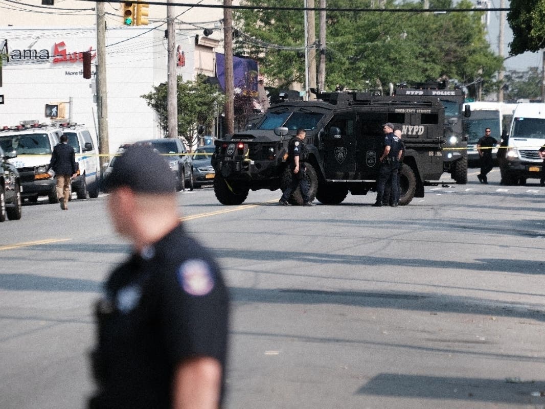Police gather at a crime scene following a stand-off in front of the 45th Police Precinct in the Bronx on July 8.