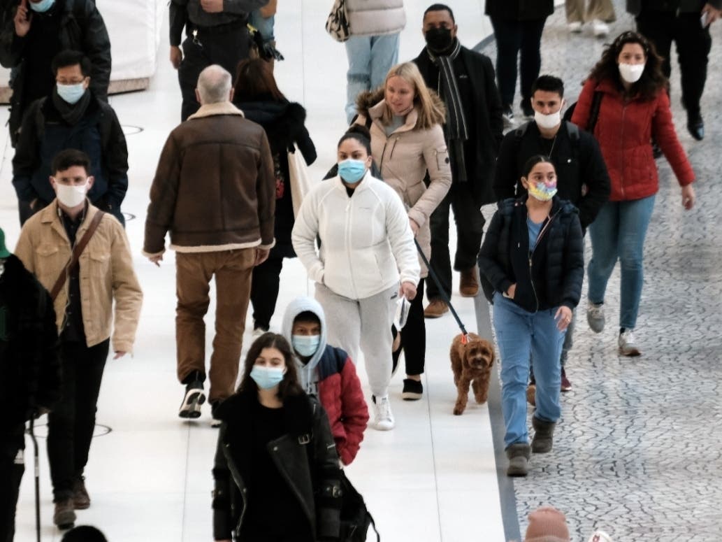 People wear masks at an indoor mall in the Oculus in Lower Manhattan on the day that a mask mandate went into effect in New York on Monday.