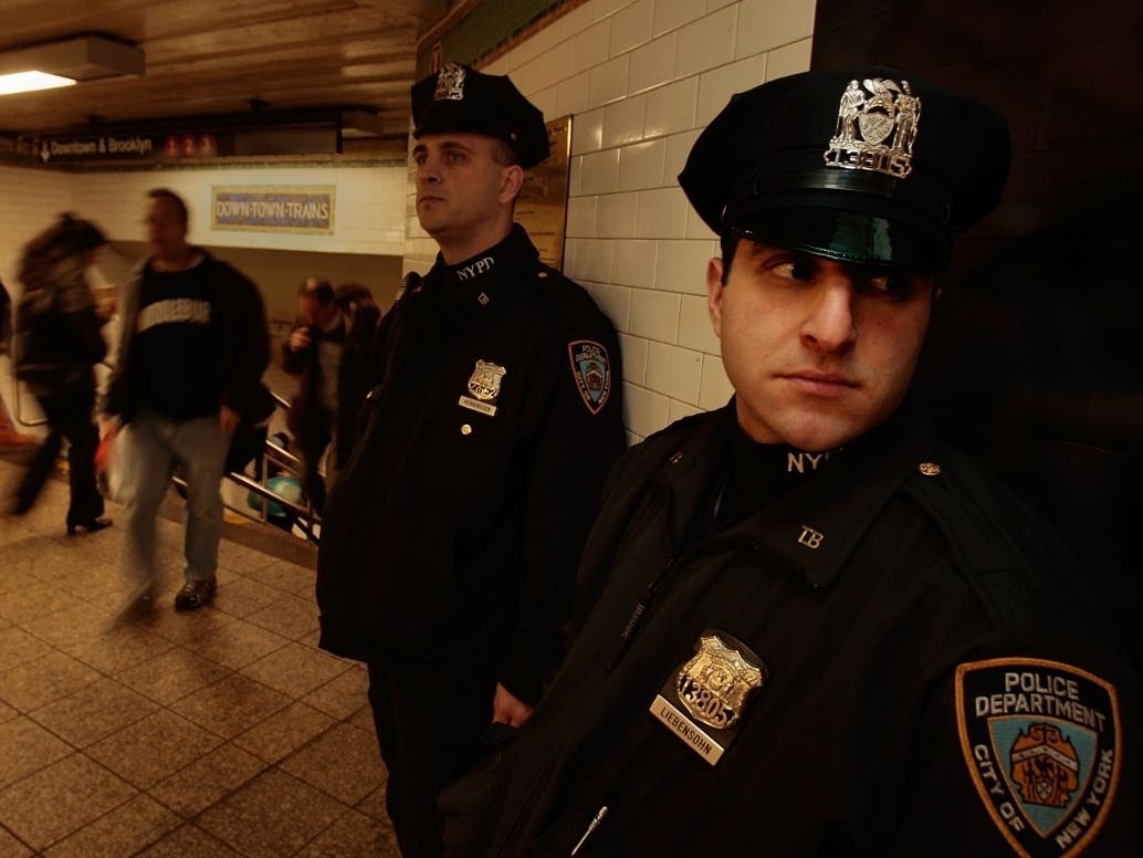 NYPD officers keep watch in part of Times Square subway station Nov. 26, 2008.