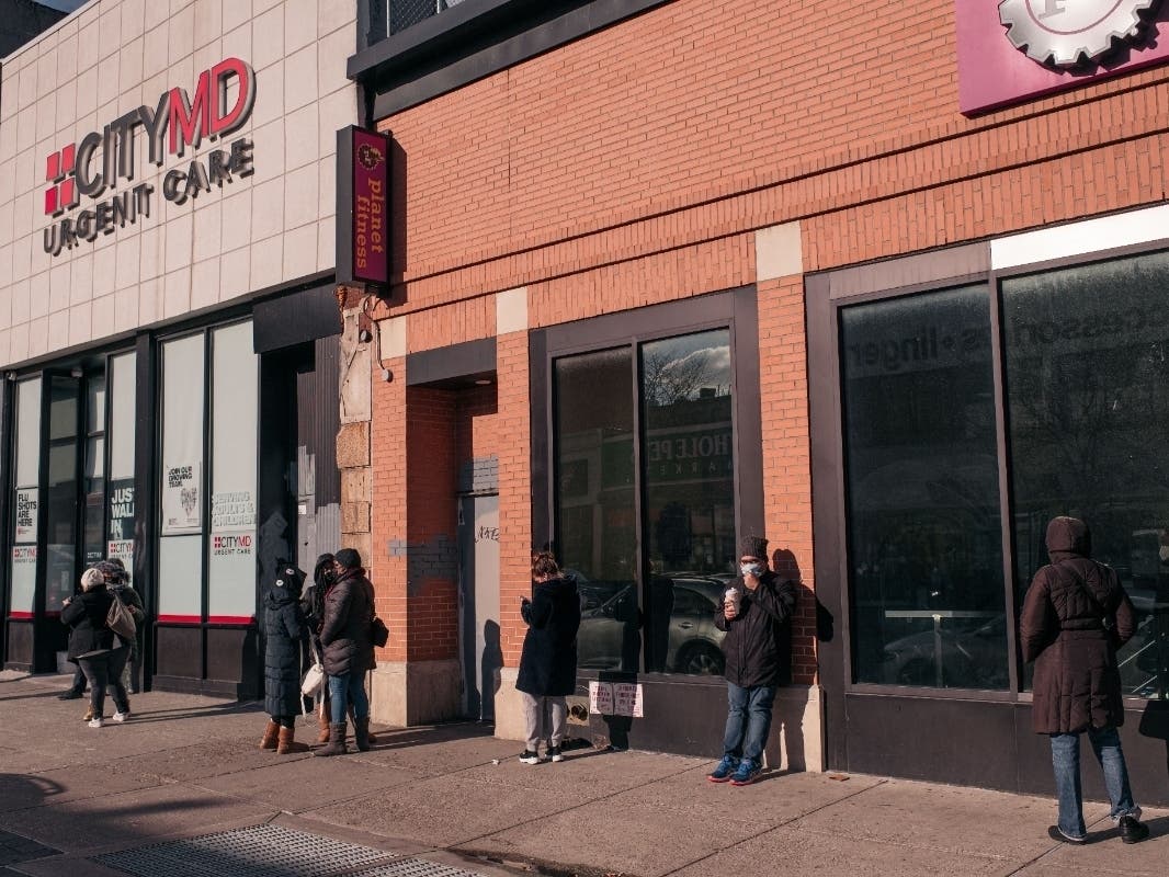 Residents wait in line Monday at a CityMD location to receive a COVID-19 test in Bed-Stuy.
