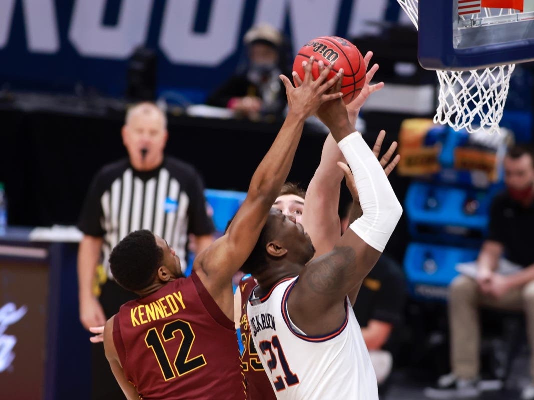 Marquise Kennedy blocks the shot of Illinois' Kofi Cockburn during the first half in the NCAA Basketball Tournament second round at Bankers Life Fieldhouse on Sunday.