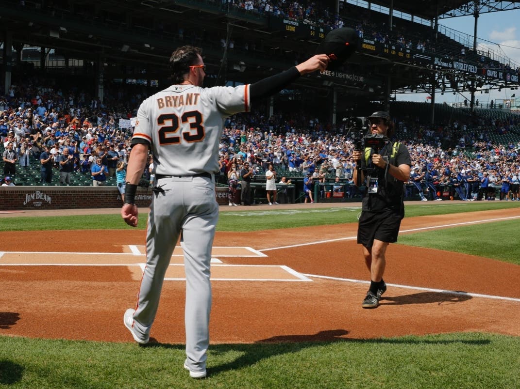 Former Cubs third baseman Kris Bryant acknowledges the crowd at Wrigley Field on Friday when he received a standing ovation and was honored with a tribute video. 