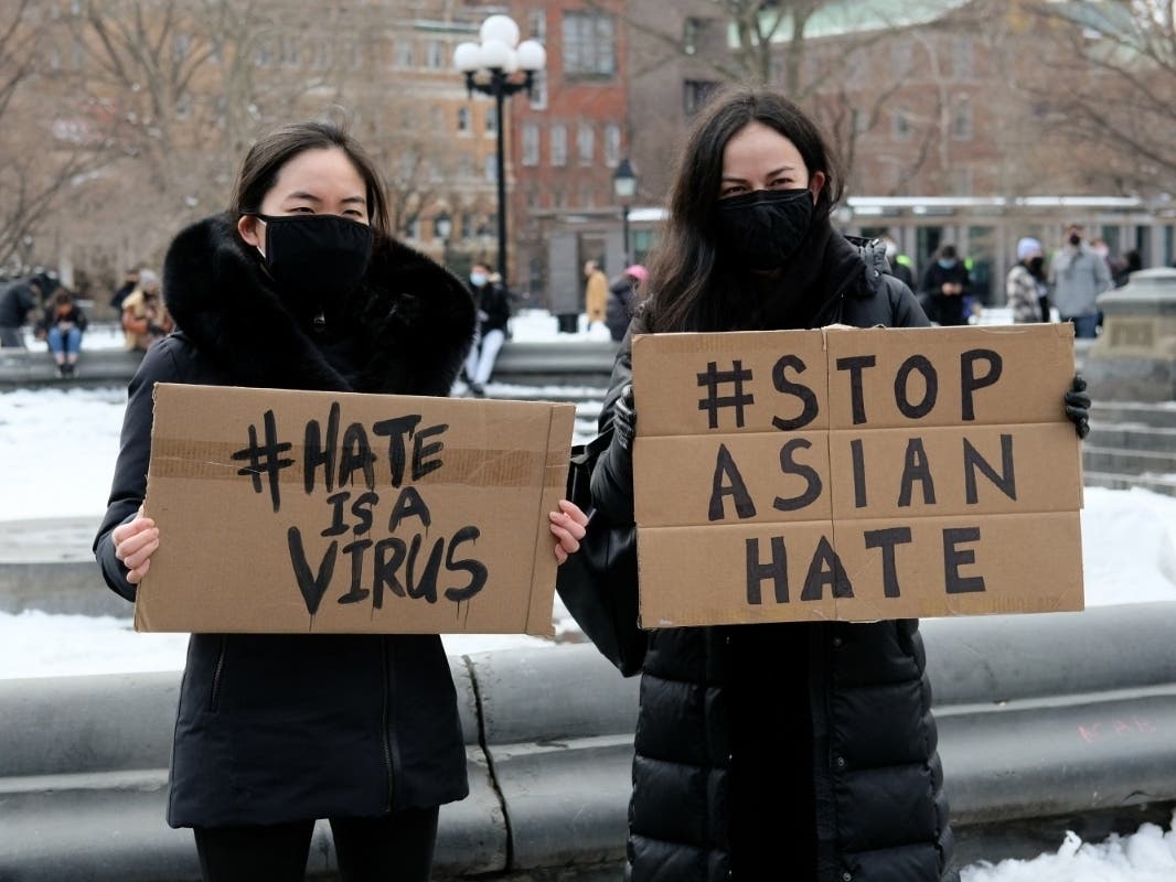 Teaneck's rally and vigil follows others in neighboring New York City. Pictured here, protestors hold signs that read "hate is a virus" and "stop Asian hate" at the End The Violence Towards Asians rally in Washington Square Park on February 20.