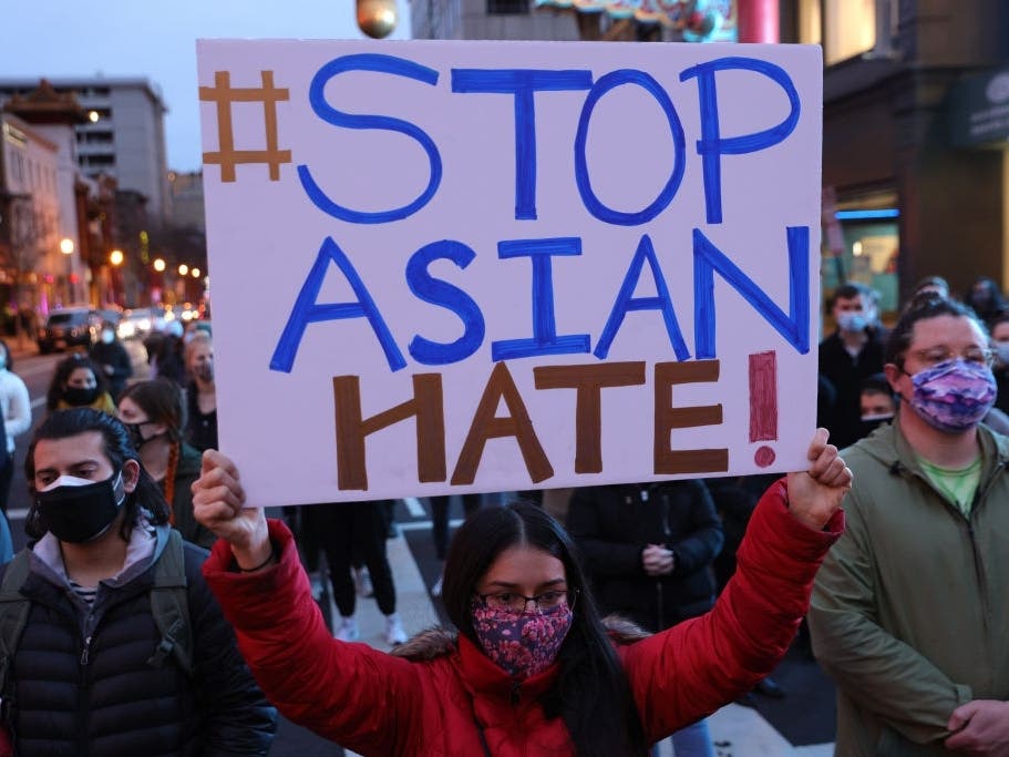 Activists participate in a vigil in response to the Atlanta spa shootings March 17, 2021 in the Chinatown area of Washington, DC. 