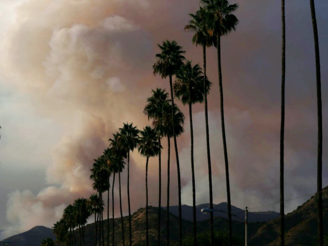 A plume of smoke rises from the Ranch 2 Fire on August 15, 2020 as seen from Azusa, California.