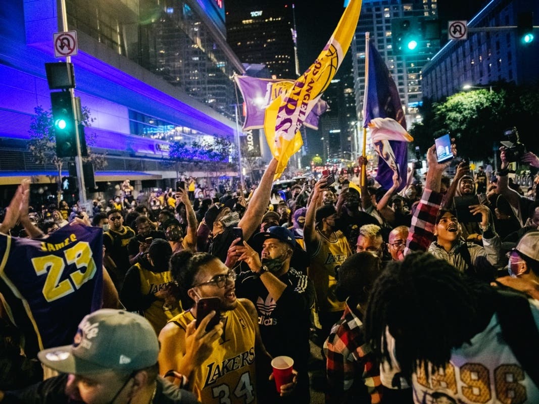 LOS ANGELES, CA - OCTOBER 11: Lakers fans celebrate in front of the Staples Center on October 11, 2020 in Los Angeles, California.